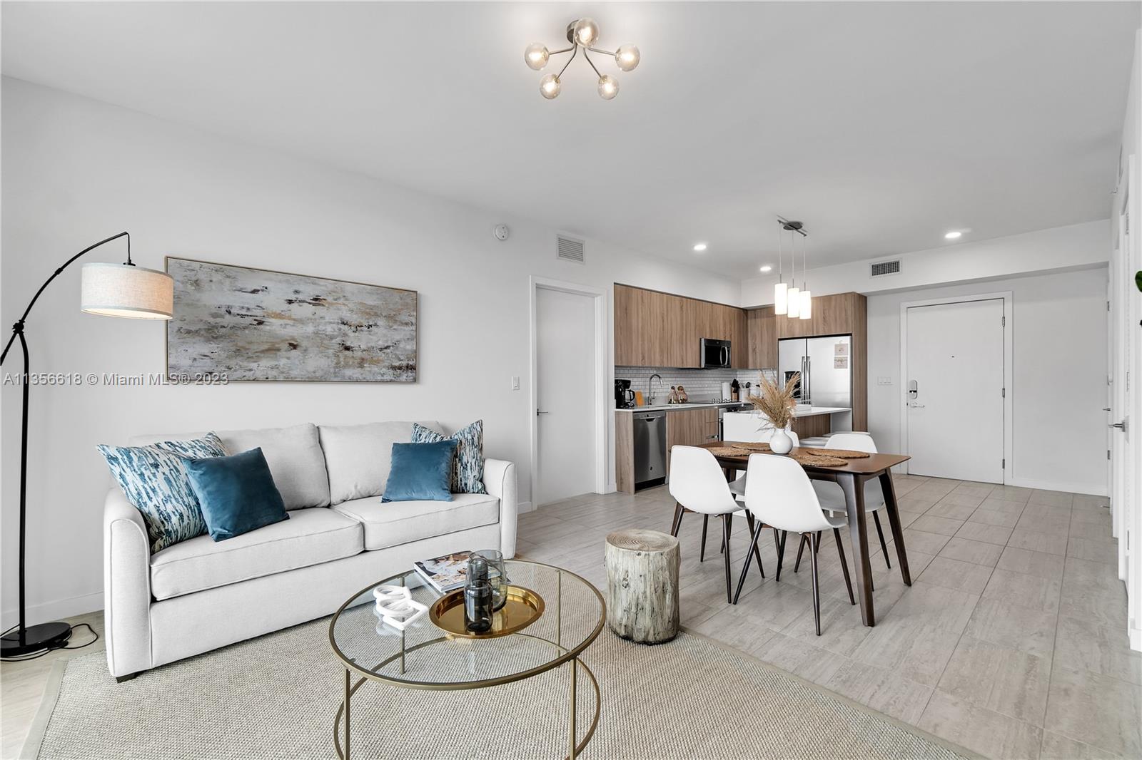 3900 Biscayne Boulevard, Unit S320 Miami, FL 33137 - Photo 5 of 42 a living room with furniture and kitchen view