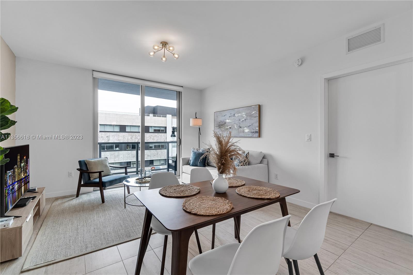 3900 Biscayne Boulevard, Unit S320 Miami, FL 33137 - Photo 10 of 42 a view of a dining room with furniture and window