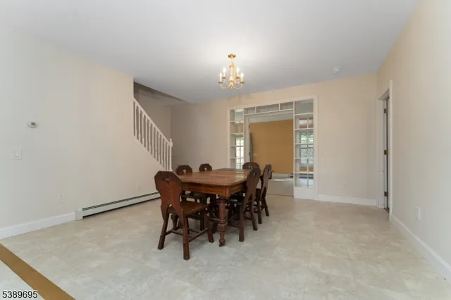 a view of a dining room with furniture and chandelier