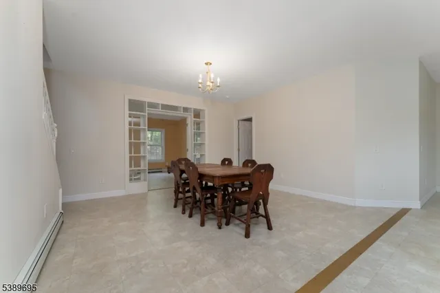 a view of a dining room with furniture and chandelier