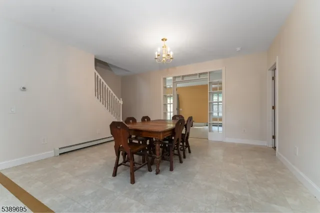 a view of a dining room with furniture and chandelier