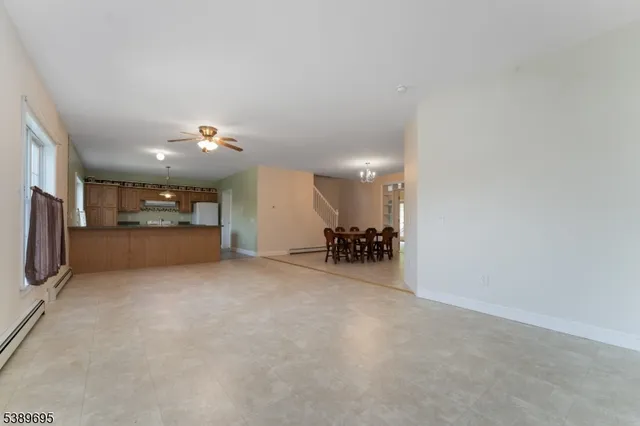 a view of an empty room with a kitchen