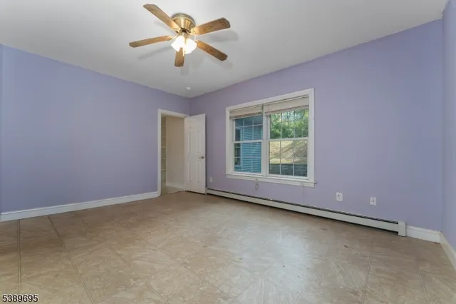 a view of room with window and ceiling fan