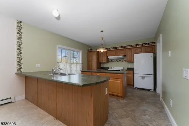 a kitchen with refrigerator and window