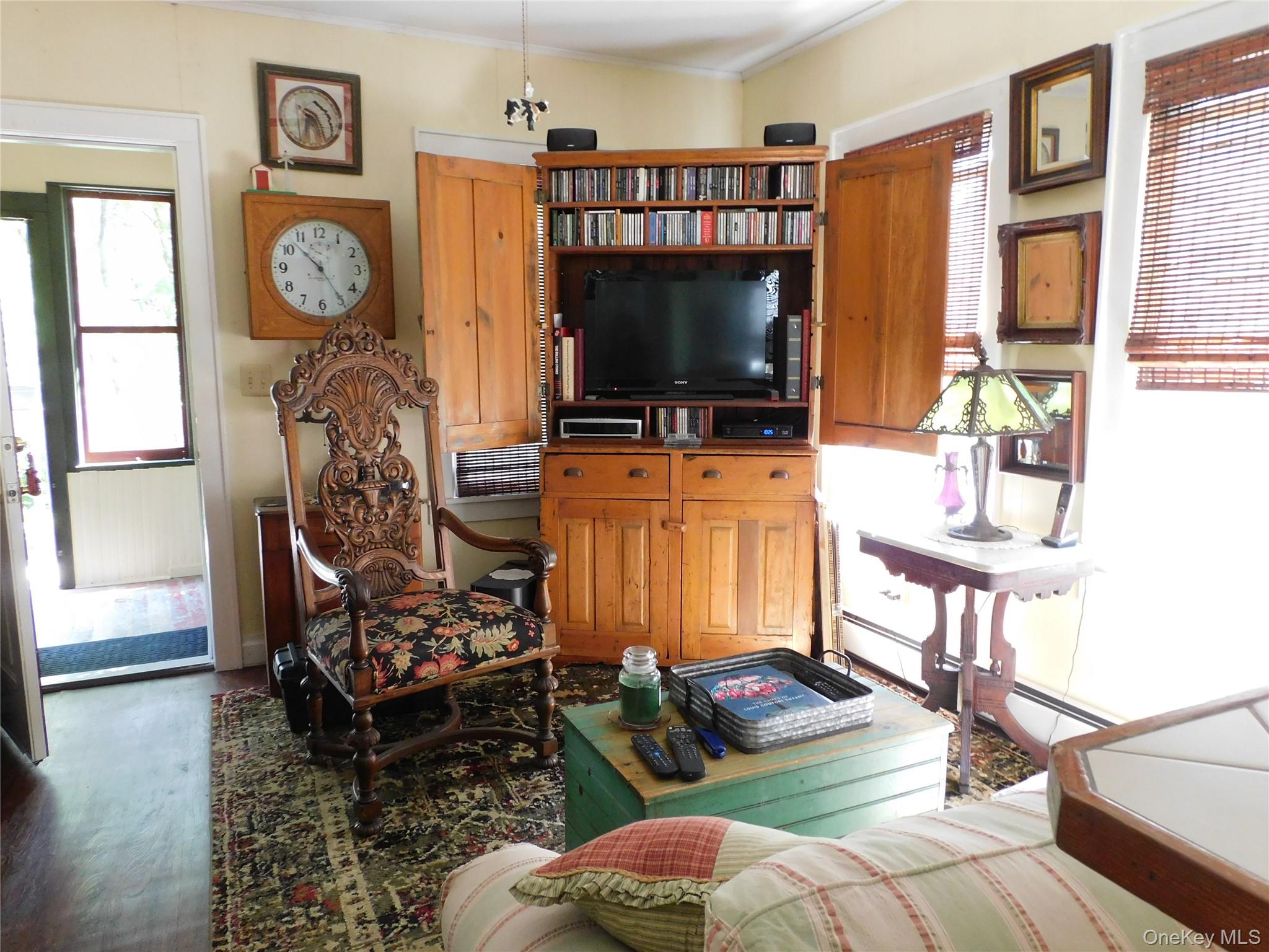 18-20 Church Road Mountain Dale, NY 12763 - Photo 13 of 20 a living room with furniture a flat screen tv and floor to ceiling window