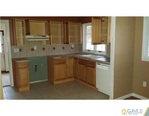 135 Princeton Road Old Bridge, NJ 08859 - Photo 6 of 7 a open kitchen with granite countertop a sink dishwasher stove and cabinets