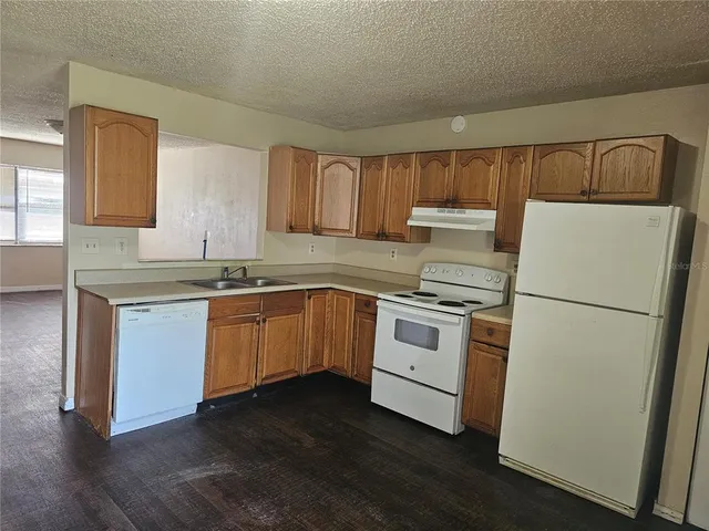 a kitchen with a white cabinets and white appliances