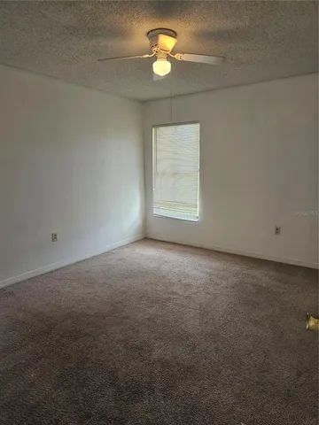 an empty room with a empty space and a ceiling fan