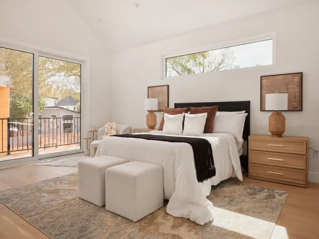 a bedroom with a bed and glass window