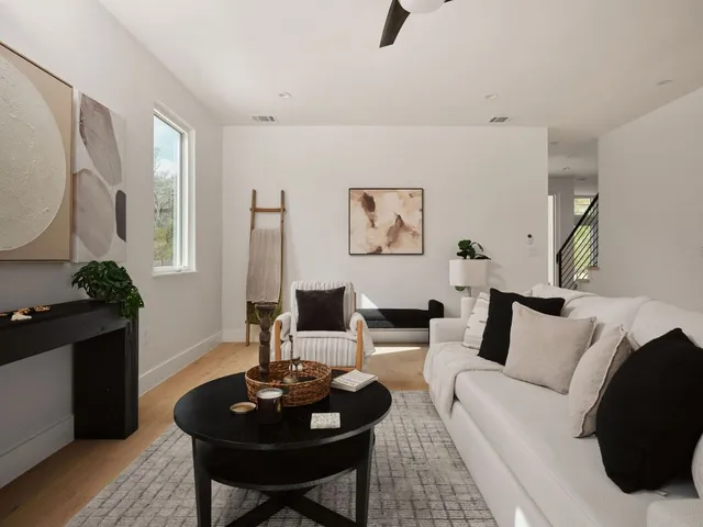 a living room with furniture and a wooden floor