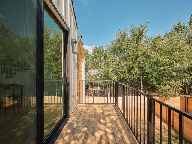 a view of a balcony with wooden floor