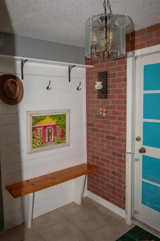 a view of a hallway with brick walls