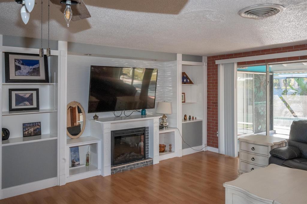 3465 Gulf Lane Rotonda West, FL 33947 - Photo 15 of 42 a living room with fireplace furniture and a flat screen tv