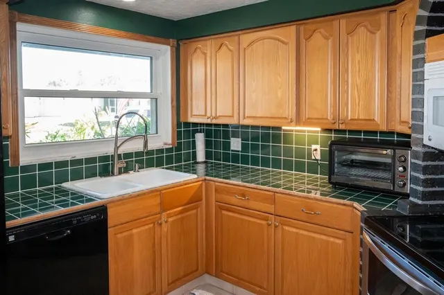 a view of a kitchen with a sink and a large window