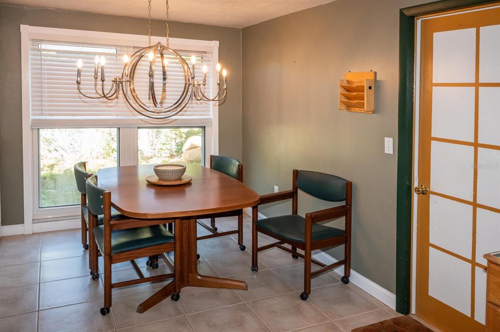 3465 Gulf Lane Rotonda West, FL 33947 - Photo 23 of 42 a view of a dining room with furniture and a window