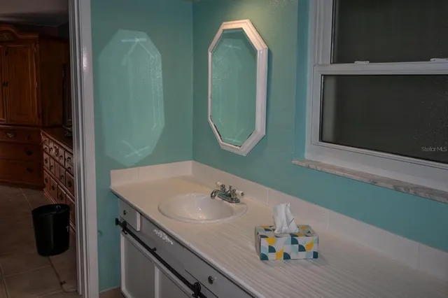 a bathroom with a sink and a mirror
