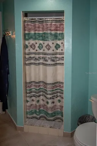 a view of bathroom with shower and toilet