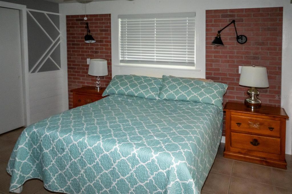 3465 Gulf Lane Rotonda West, FL 33947 - Photo 28 of 42 a bedroom with a bed and a window