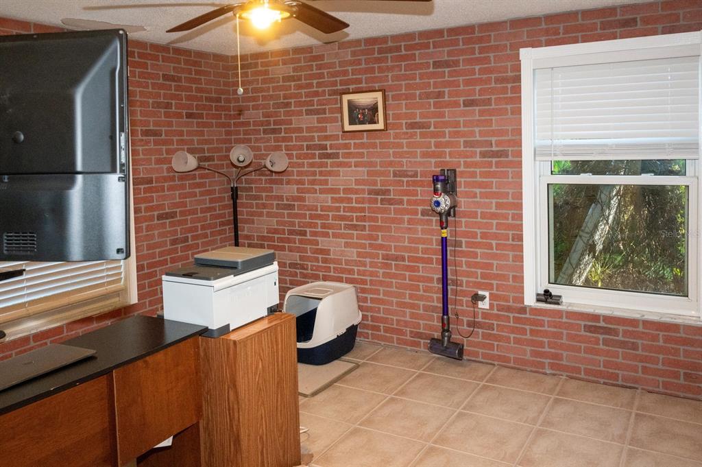 3465 Gulf Lane Rotonda West, FL 33947 - Photo 33 of 42 a brick house with a sink and a potted plant