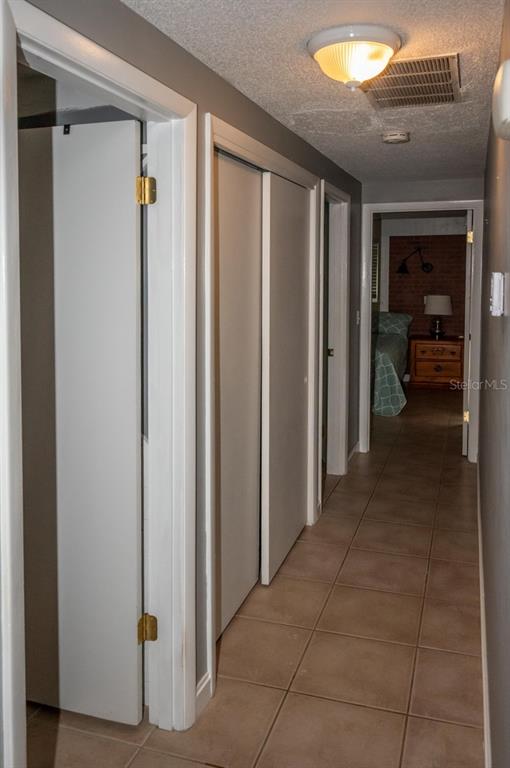 3465 Gulf Lane Rotonda West, FL 33947 - Photo 34 of 42 a view of a hallway with closet and a livingroom view