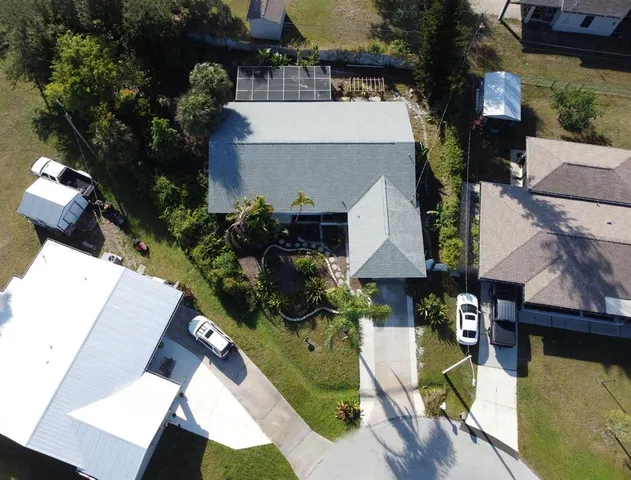 an aerial view of a house with swimming pool and garden