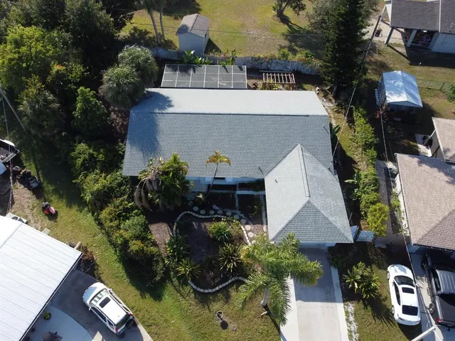 an aerial view of a house with a yard and garden