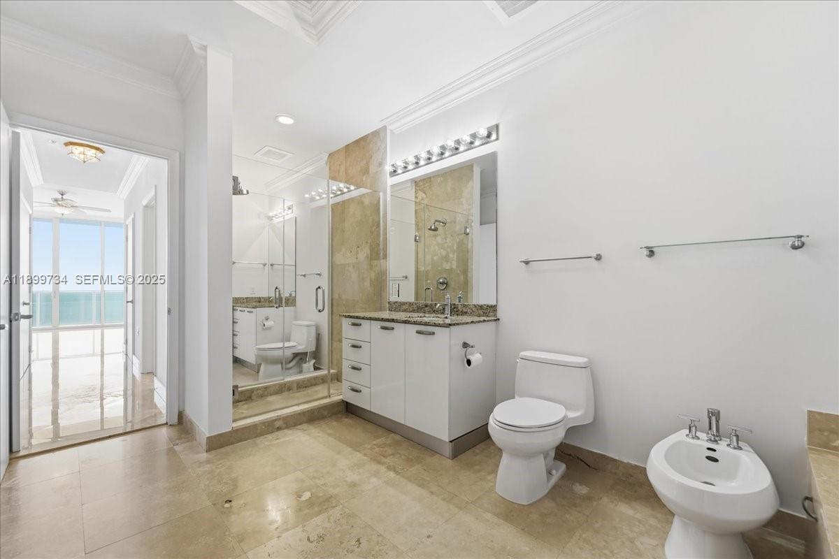 704 North Ocean Boulevard, Unit 1002 Pompano Beach, FL 33062 - Photo 16 of 57 a bathroom with a toilet a sink and a large mirror