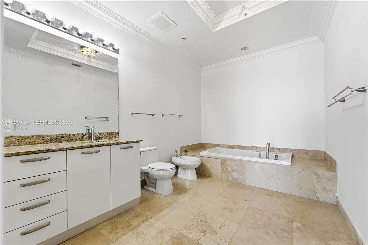 704 North Ocean Boulevard, Unit 1002 Pompano Beach, FL 33062 - Photo 18 of 57 a bathroom with a granite countertop sink a toilet and bathtub