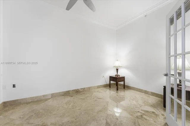 a living room with furniture a large window and kitchen view