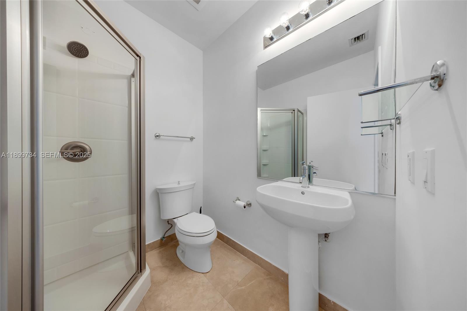 704 North Ocean Boulevard, Unit 1002 Pompano Beach, FL 33062 - Photo 31 of 57 a bathroom with a sink toilet and shower