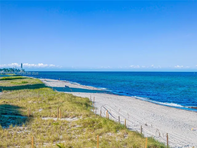 a view of roof deck with table and chairs