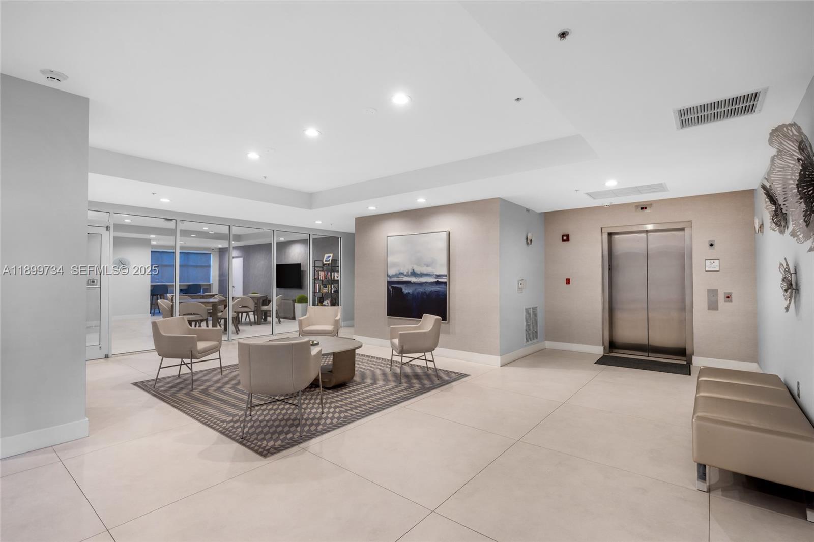 704 North Ocean Boulevard, Unit 1002 Pompano Beach, FL 33062 - Photo 42 of 57 a living room with furniture a large window and kitchen view