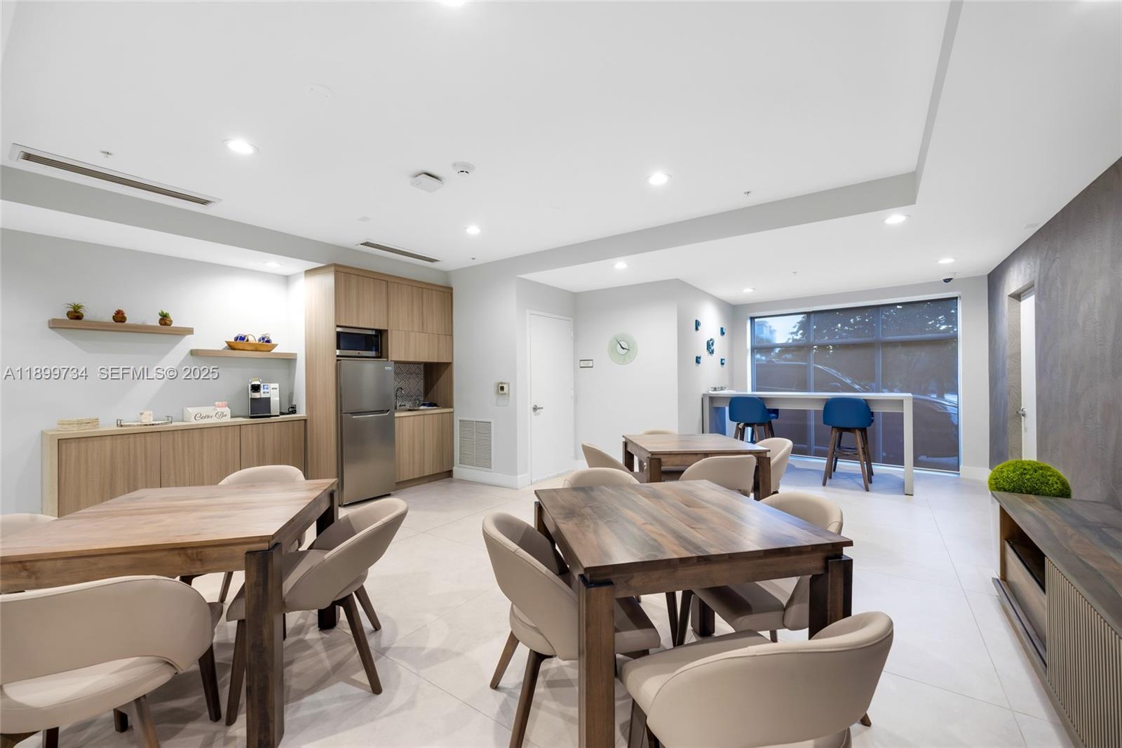 704 North Ocean Boulevard, Unit 1002 Pompano Beach, FL 33062 - Photo 43 of 57 a living room with furniture and a dining table with kitchen view