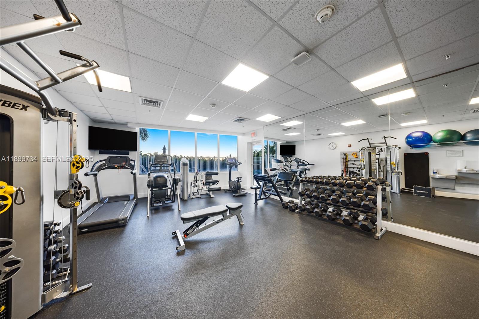 704 North Ocean Boulevard, Unit 1002 Pompano Beach, FL 33062 - Photo 45 of 57 a view of a room with gym equipment