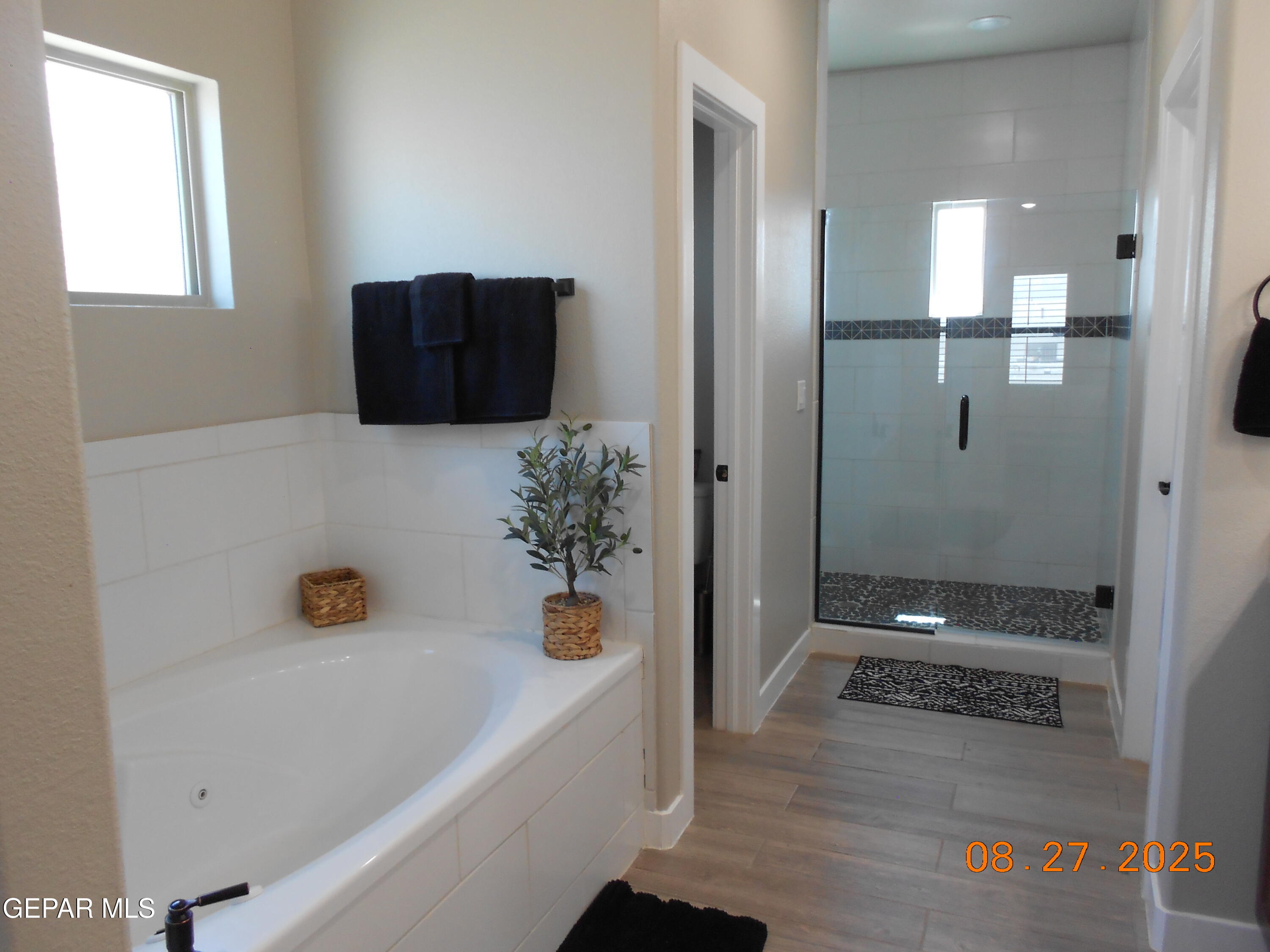 10013 Hueco Jct Road Socorro, TX 79927 - Photo 13 of 28 a bathroom with a tub shower and vanity