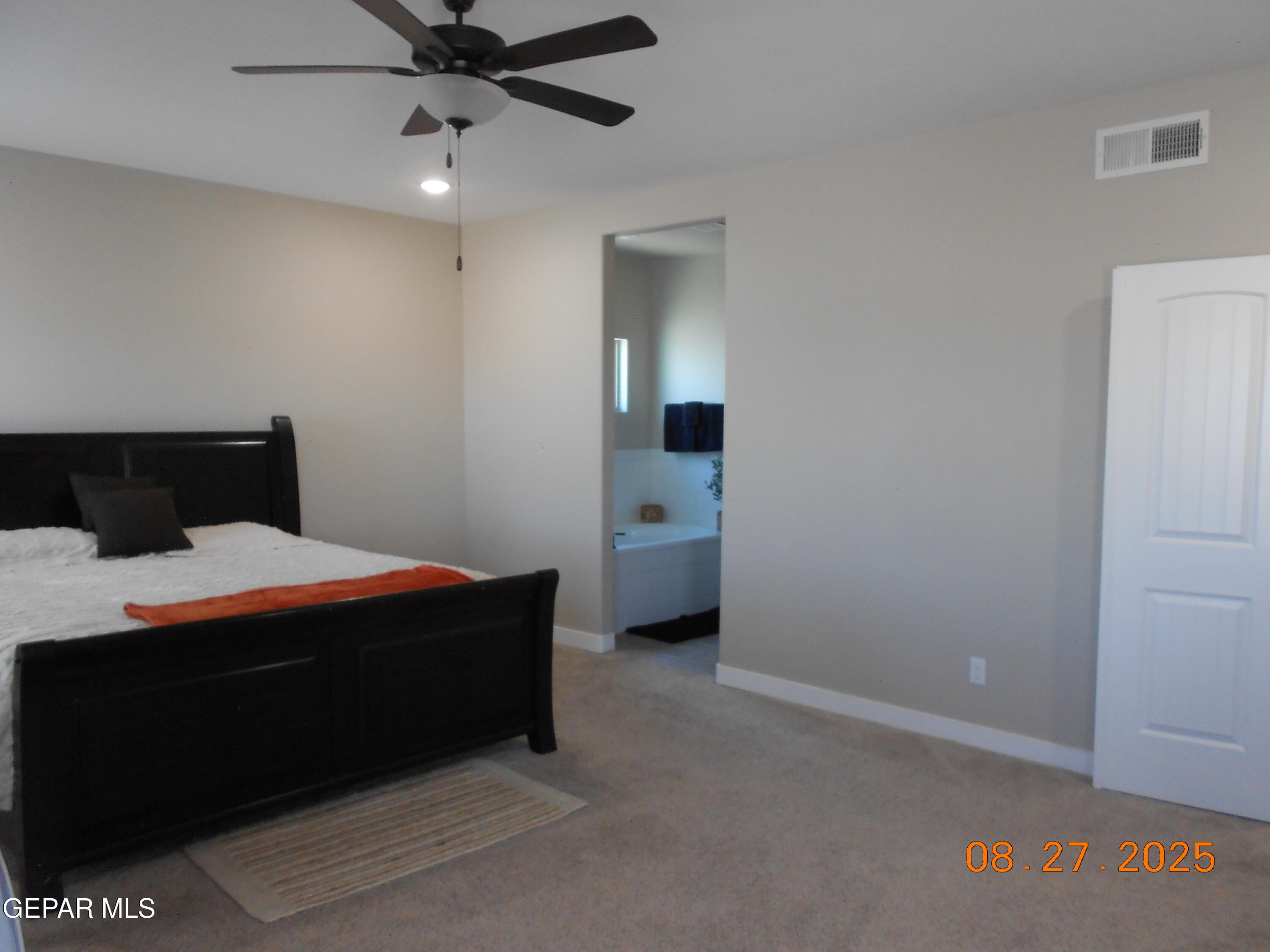 10013 Hueco Jct Road Socorro, TX 79927 - Photo 10 of 28 a bedroom with a bed and a chandelier
