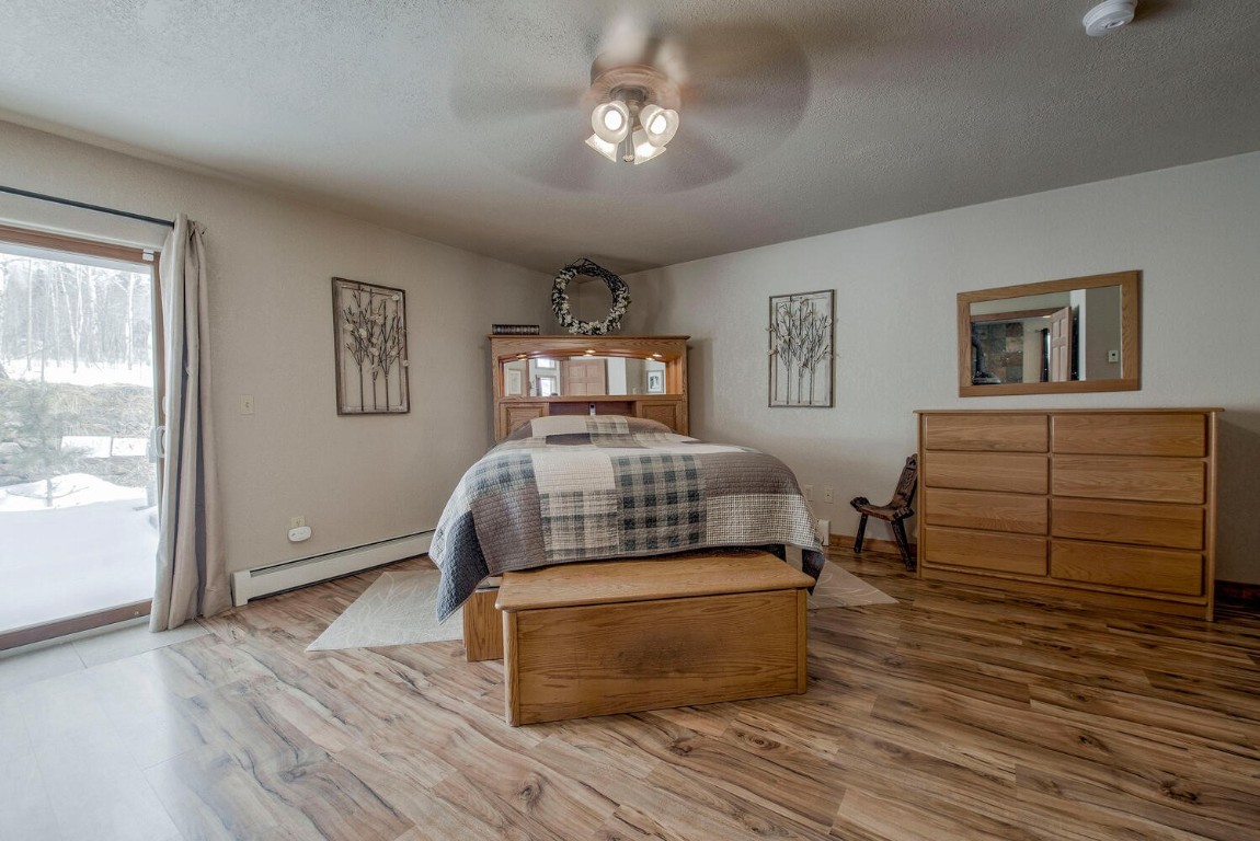 1462 Sheep Ridge Road Fairplay, CO 80440 - Photo 19 of 48 a bedroom with a bed and wooden floor
