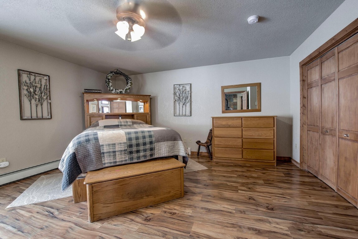 1462 Sheep Ridge Road Fairplay, CO 80440 - Photo 20 of 48 a bedroom with a bed and wooden floor