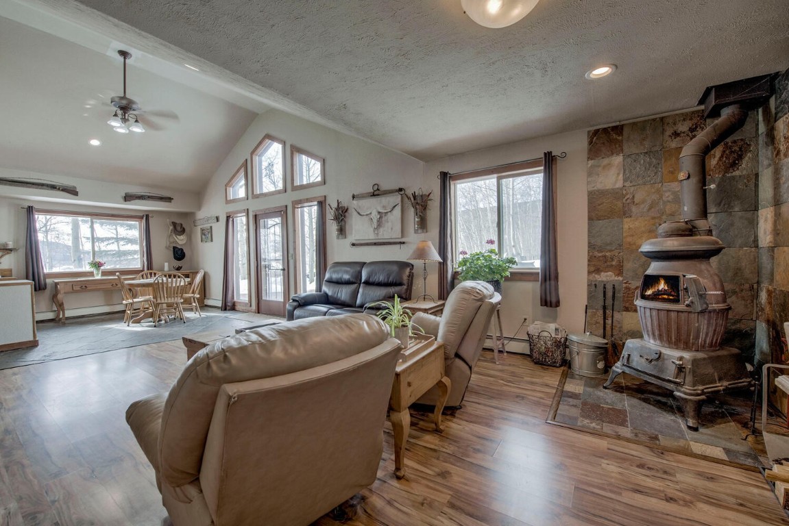 1462 Sheep Ridge Road Fairplay, CO 80440 - Photo 36 of 48 a living room with furniture a fireplace and a chandelier