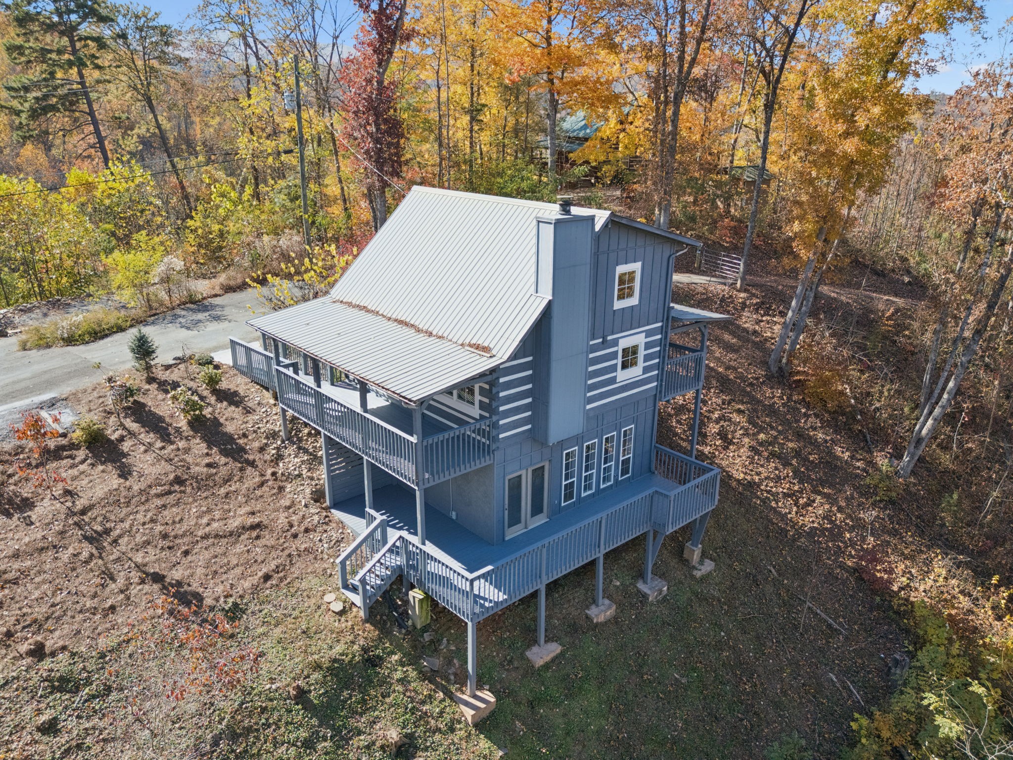 306 Beech Ridge Lane Gatlinburg, TN 37738 - Photo 12 of 24 a view of a wooden house with a yard and large trees