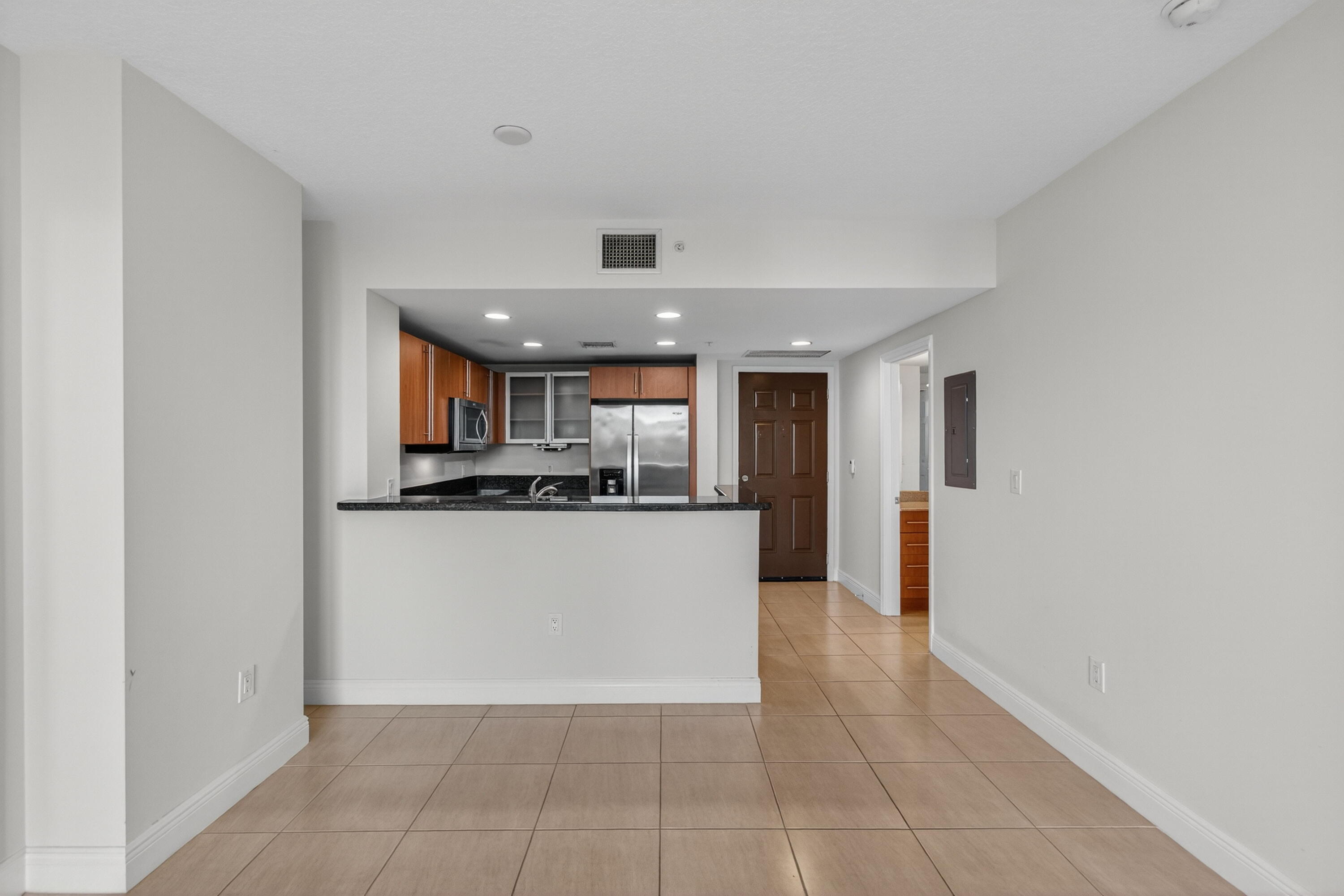 610 Clematis Street, Unit 532 West Palm Beach, FL 33401 - Photo 18 of 63 a view of kitchen with stainless steel appliances granite countertop a refrigerator and a sink