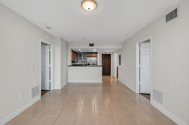 a kitchen with granite countertop wooden cabinets stainless steel appliances and a counter space