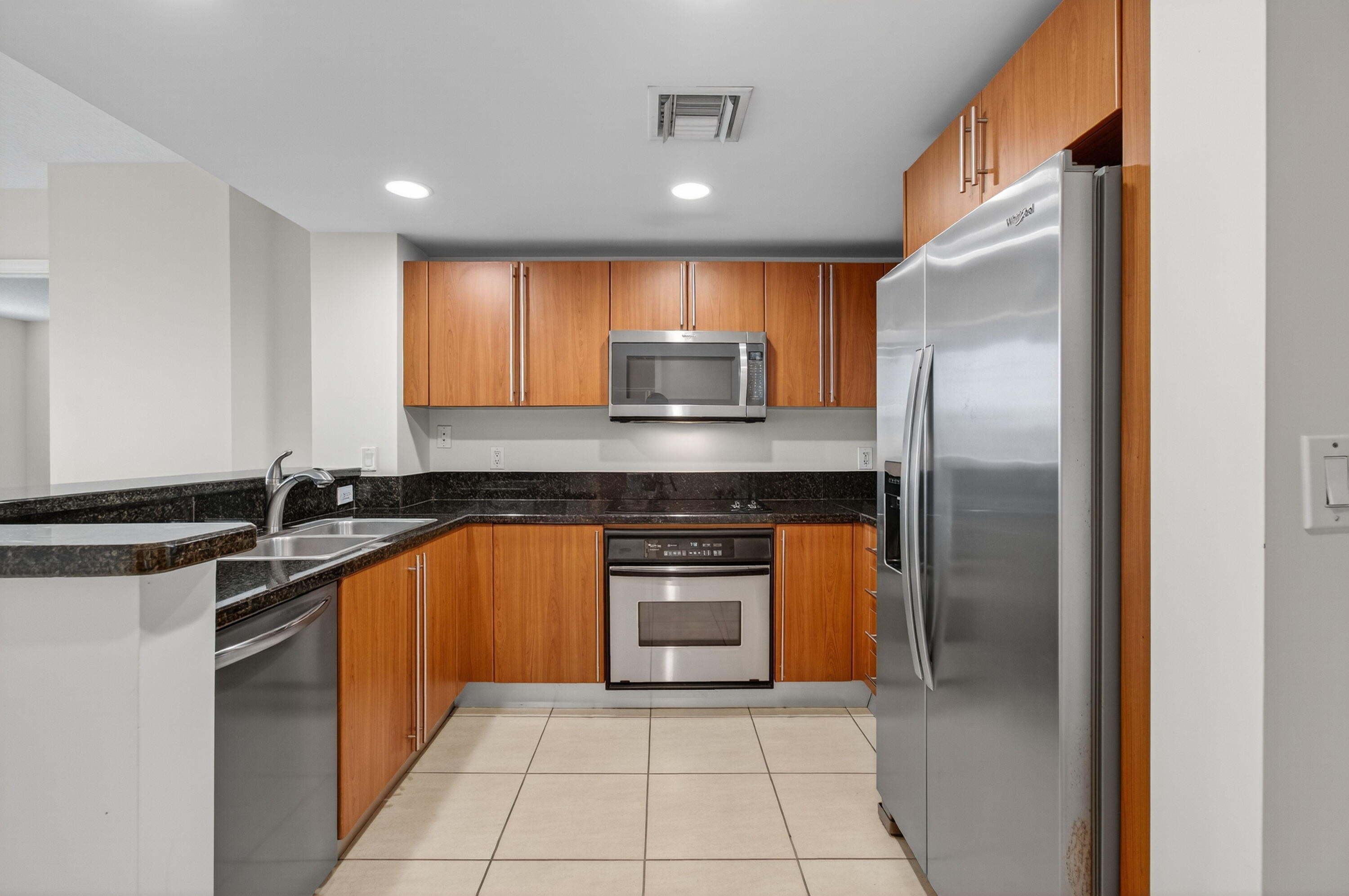 610 Clematis Street, Unit 532 West Palm Beach, FL 33401 - Photo 26 of 63 a kitchen with stainless steel appliances granite countertop a stove a sink and a refrigerator