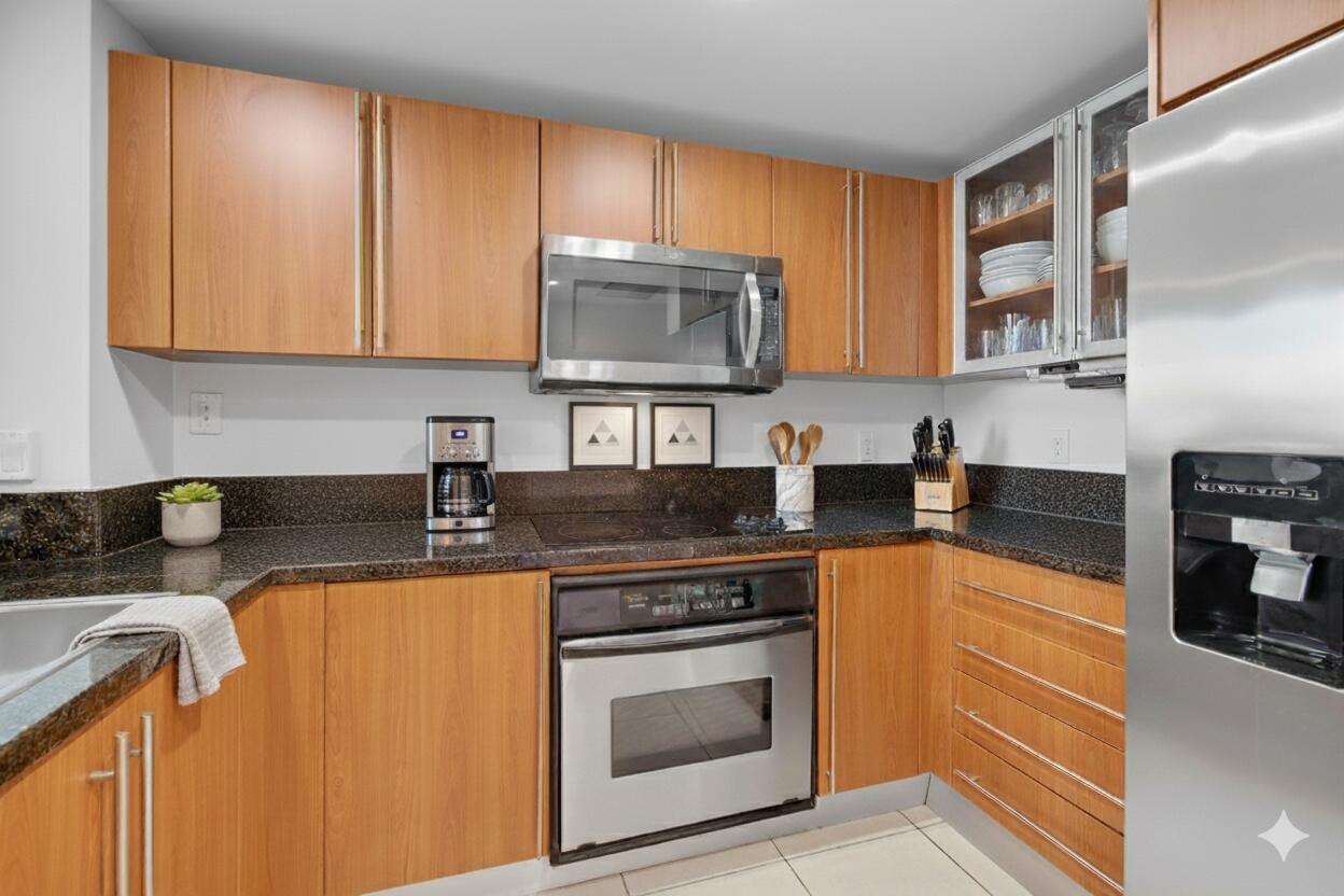 610 Clematis Street, Unit 532 West Palm Beach, FL 33401 - Photo 28 of 63 a kitchen with granite countertop a sink stove and cabinets