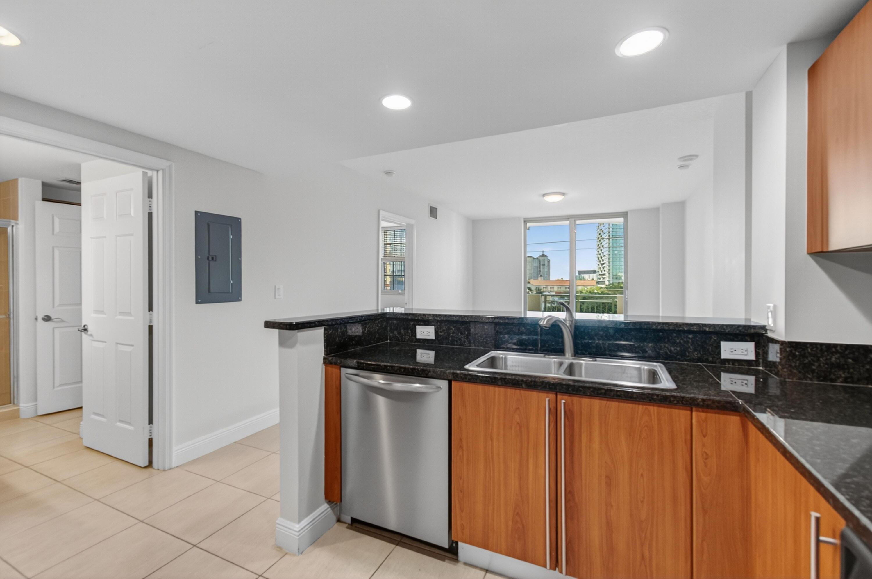 610 Clematis Street, Unit 532 West Palm Beach, FL 33401 - Photo 29 of 63 a kitchen with stainless steel appliances granite countertop a sink stove and cabinets