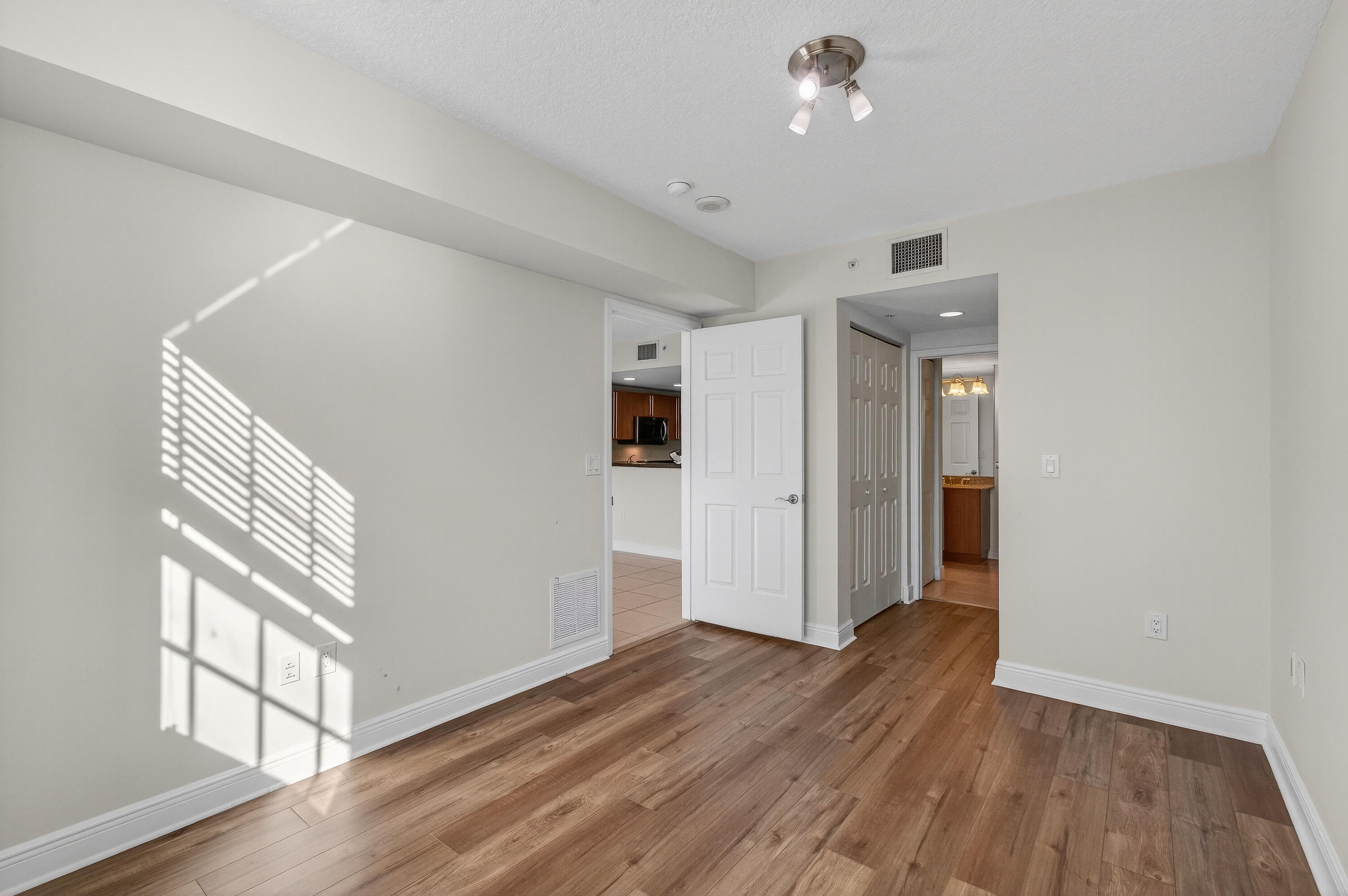 610 Clematis Street, Unit 532 West Palm Beach, FL 33401 - Photo 31 of 63 wooden floor in an empty room with a window