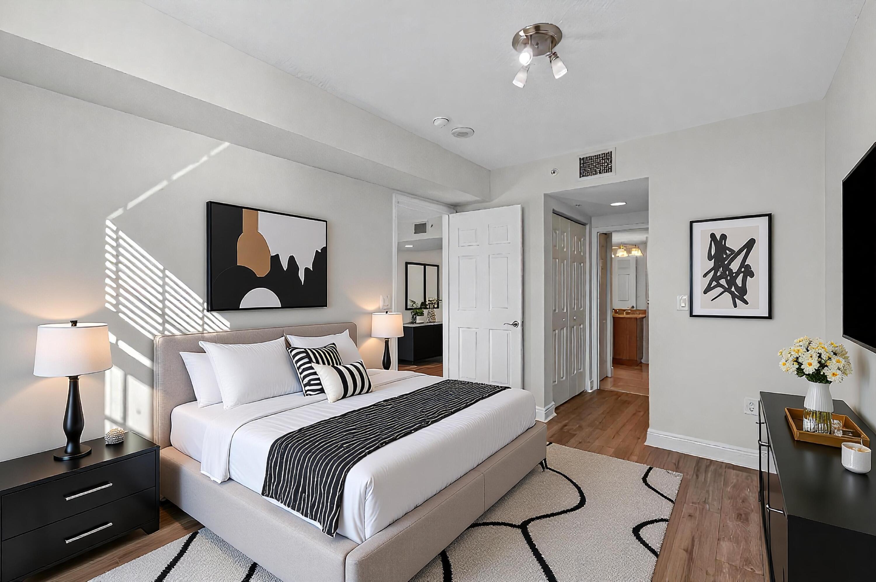 610 Clematis Street, Unit 532 West Palm Beach, FL 33401 - Photo 32 of 63 a bedroom with a bed and wooden floor