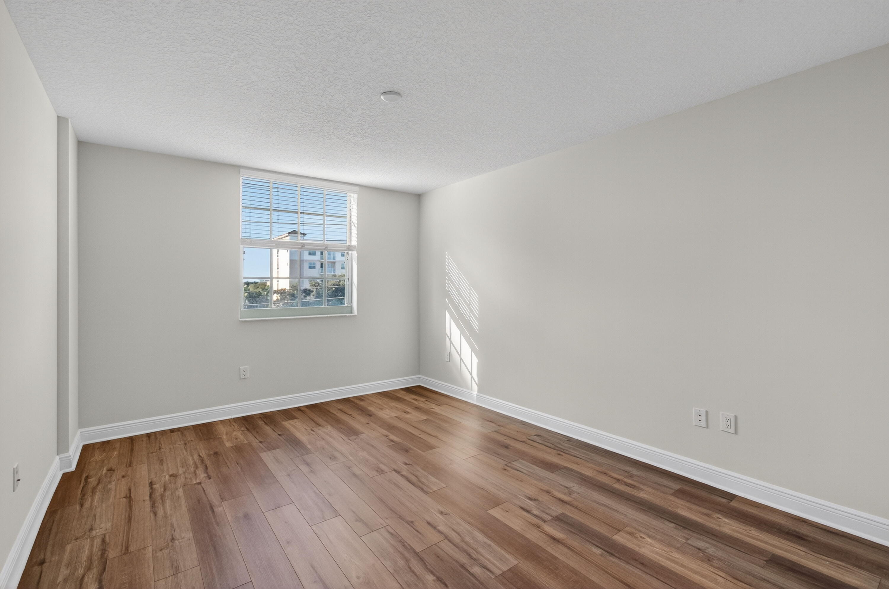 610 Clematis Street, Unit 532 West Palm Beach, FL 33401 - Photo 33 of 63 a view of an empty room with wooden floor and a window