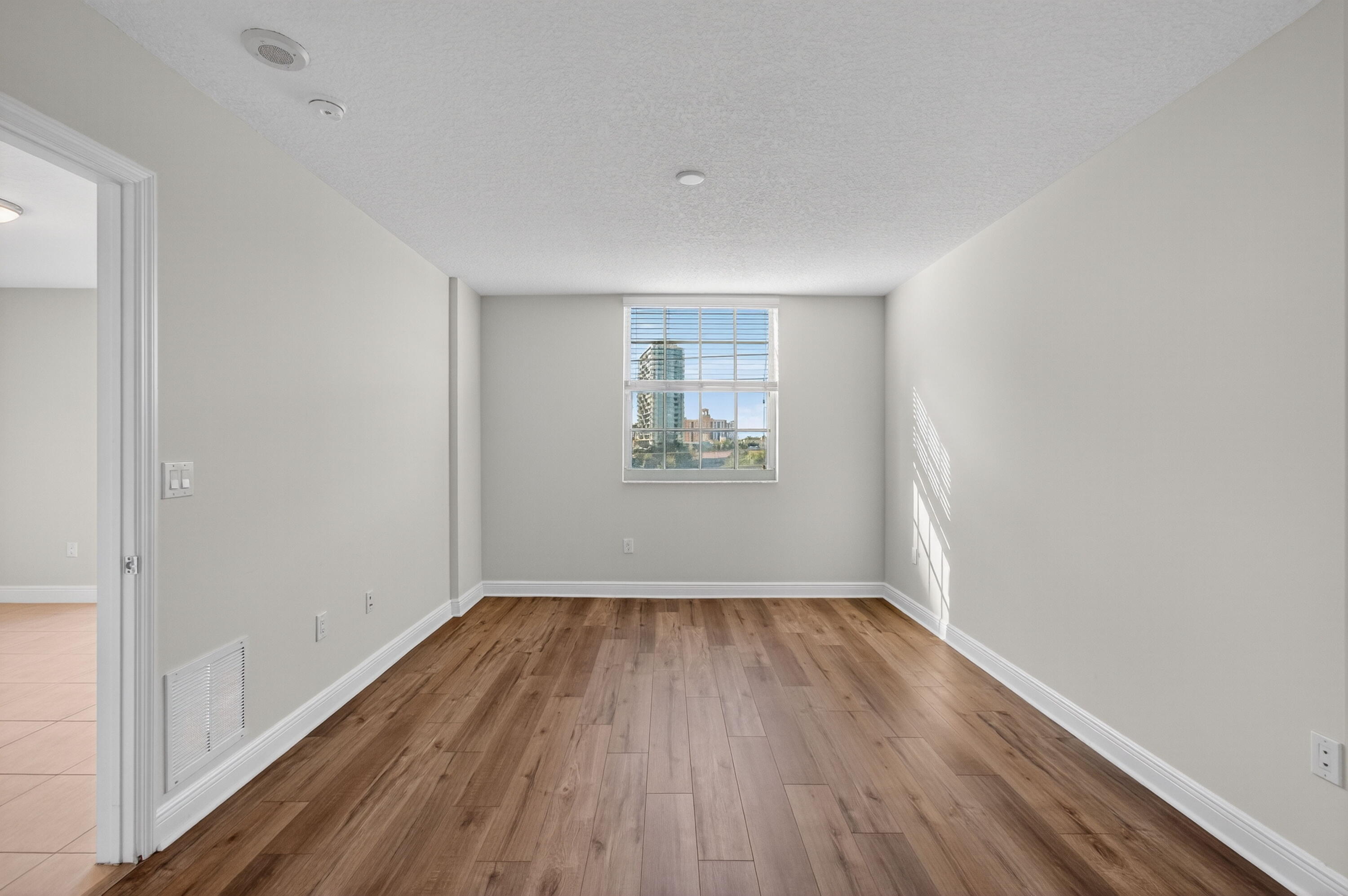 610 Clematis Street, Unit 532 West Palm Beach, FL 33401 - Photo 34 of 63 an empty room with wooden floor and windows