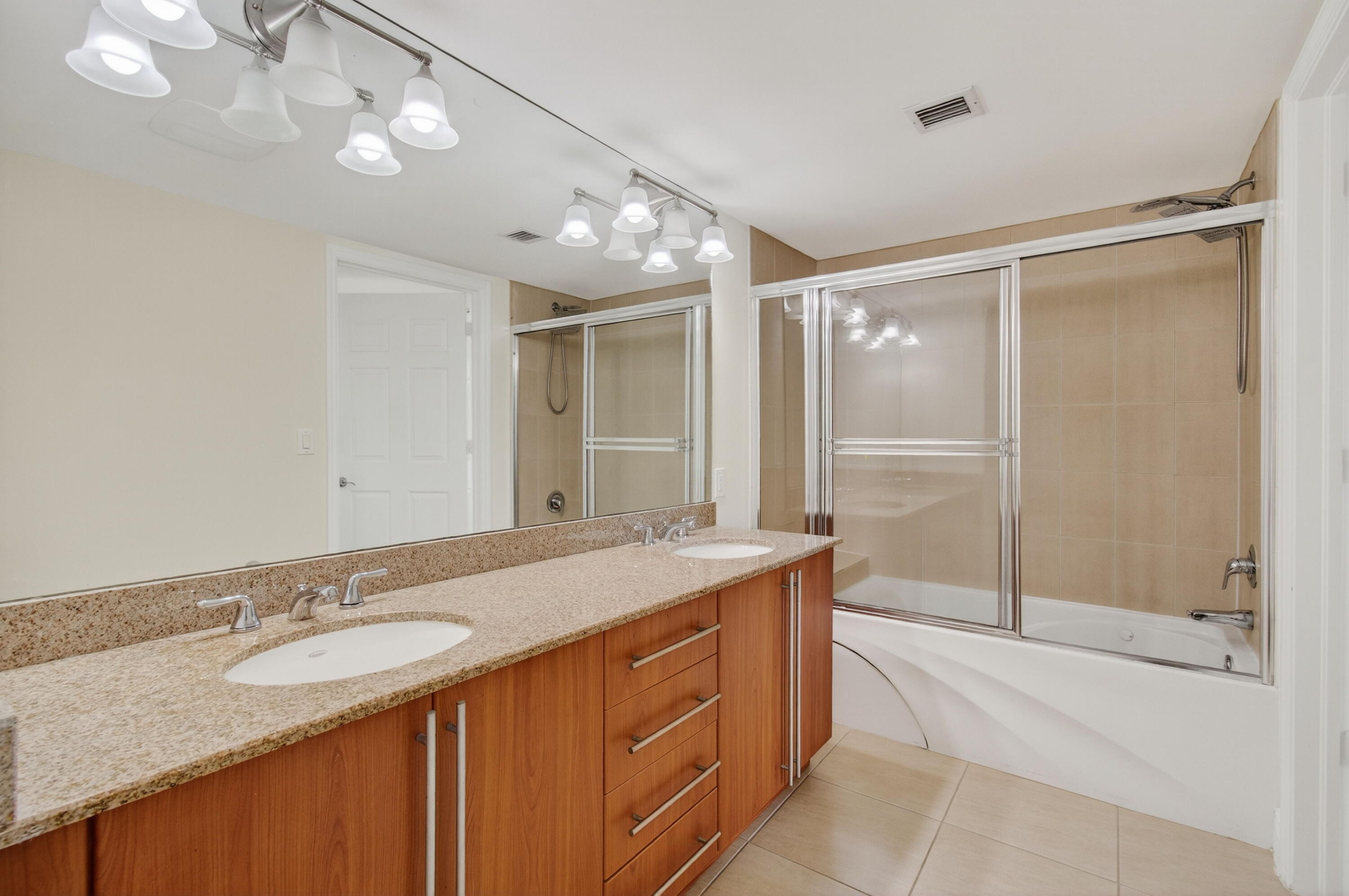 610 Clematis Street, Unit 532 West Palm Beach, FL 33401 - Photo 40 of 63 a bathroom with a granite countertop sink mirror and double